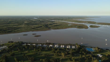 aerial establishing shot of a river mouth to la plata river in san isidro, buenos aires