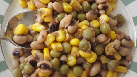 close-up of mixed vegetable salad with black-eyed peas, green peas, and corn