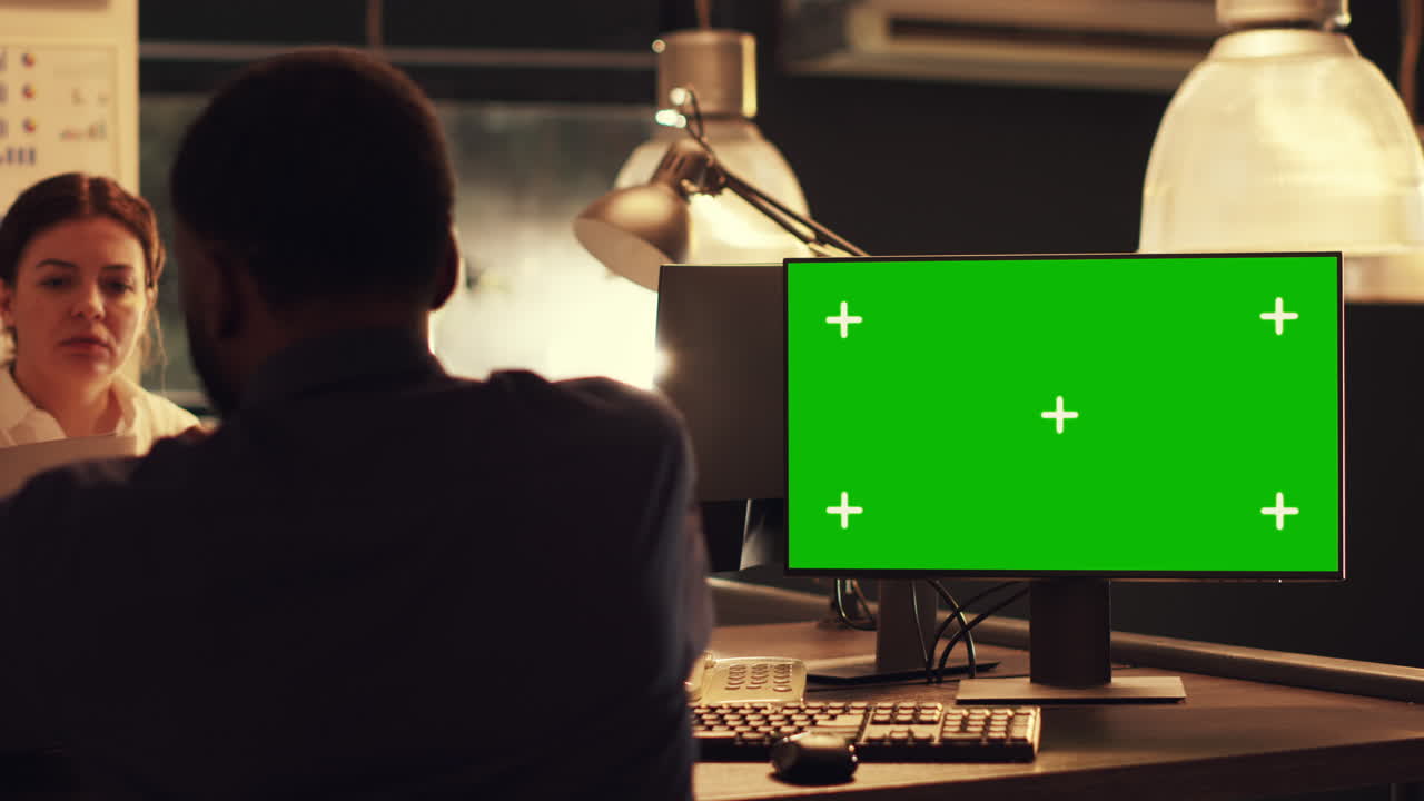 Freelancer looking at greenscreen display on computer