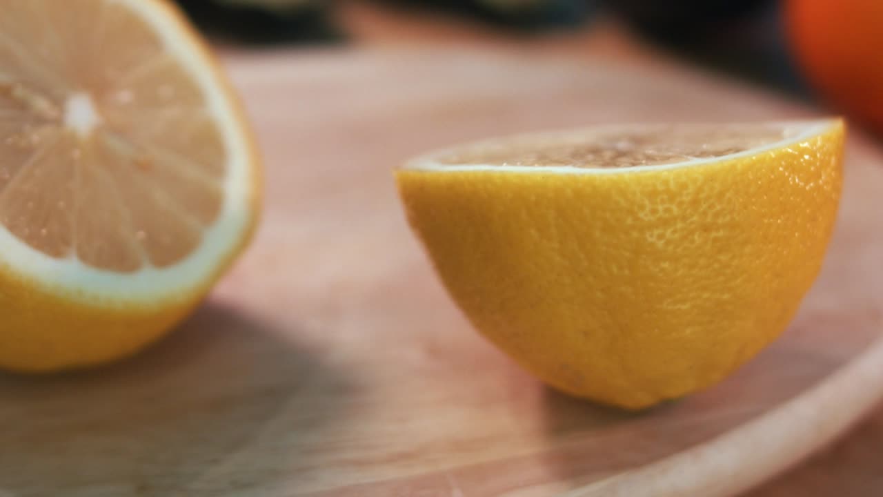 Interior Close Slow Motion Shot of Slicing Lemon Into Half in the Day