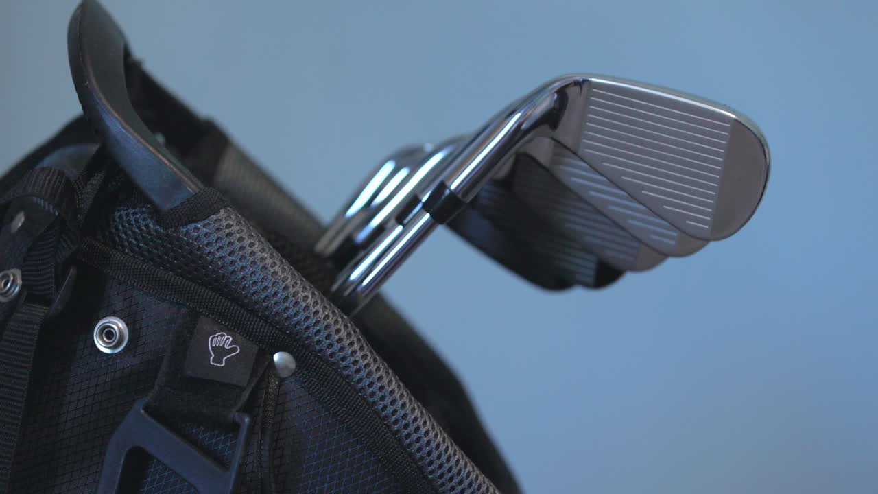 revealing shot of a brand new set of golf irons on display within a bag