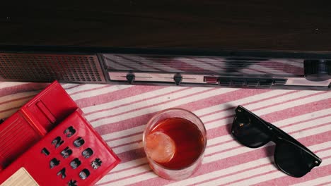 retro vintage scene with radio, phone, drink, and sunglasses