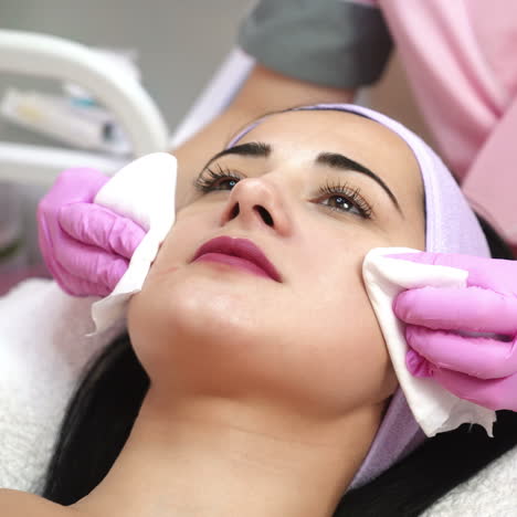 cleaning the skin, a beautiful woman in the beauty salon beauty. cosmetologist job.