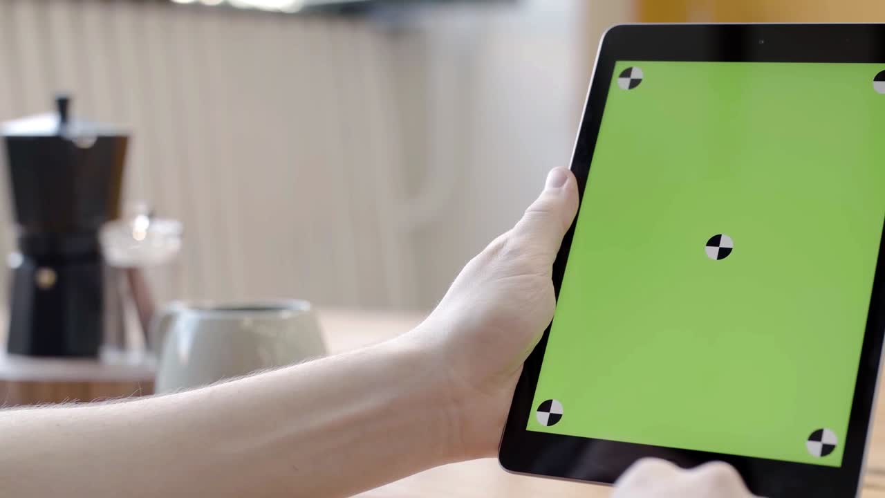 persona que utiliza una tableta con una pantalla verde