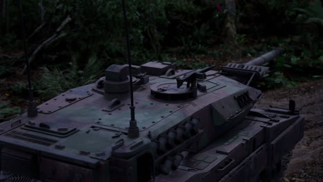military tank positioned in dense jungle environment during twilight hours