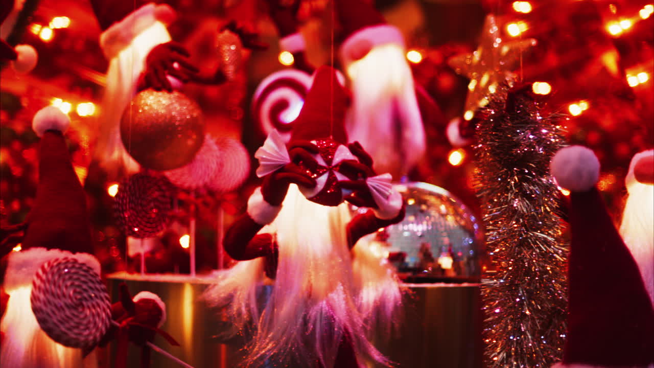 Multiple Santa Claus Christmas decorations moving in bubbles in the courtyard of the Monte Carlo Casino