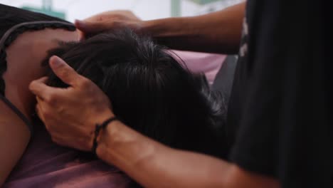 Deep-tissue-massage-performed-on-lower-and-middle-area-of-rear-skull-filmed-as-close-up-shot