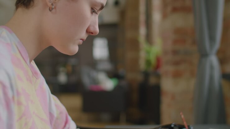 Girl with Prosthetic Arm Painting Picture at Home
