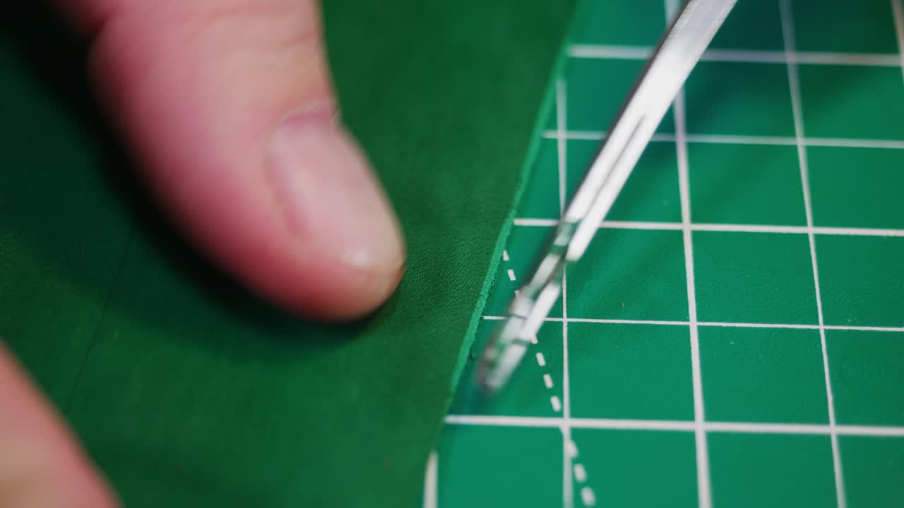 In a tanner's workshop, tools and materials are used to measure and cut leather pieces. The focus is on precise work to create leather items