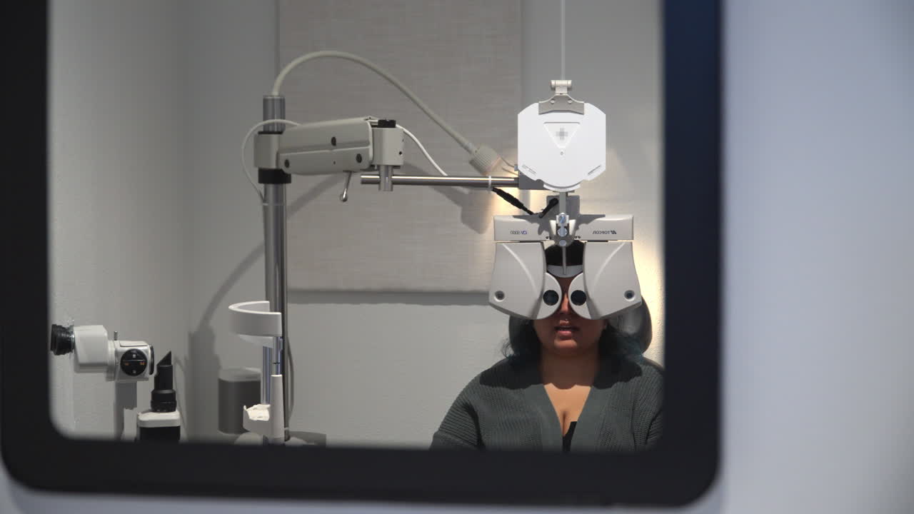 Young woman having eye exam at optometrist office, establisher