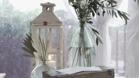 bespoke decorated side table with candle lantern, flower vase in glamping retreat