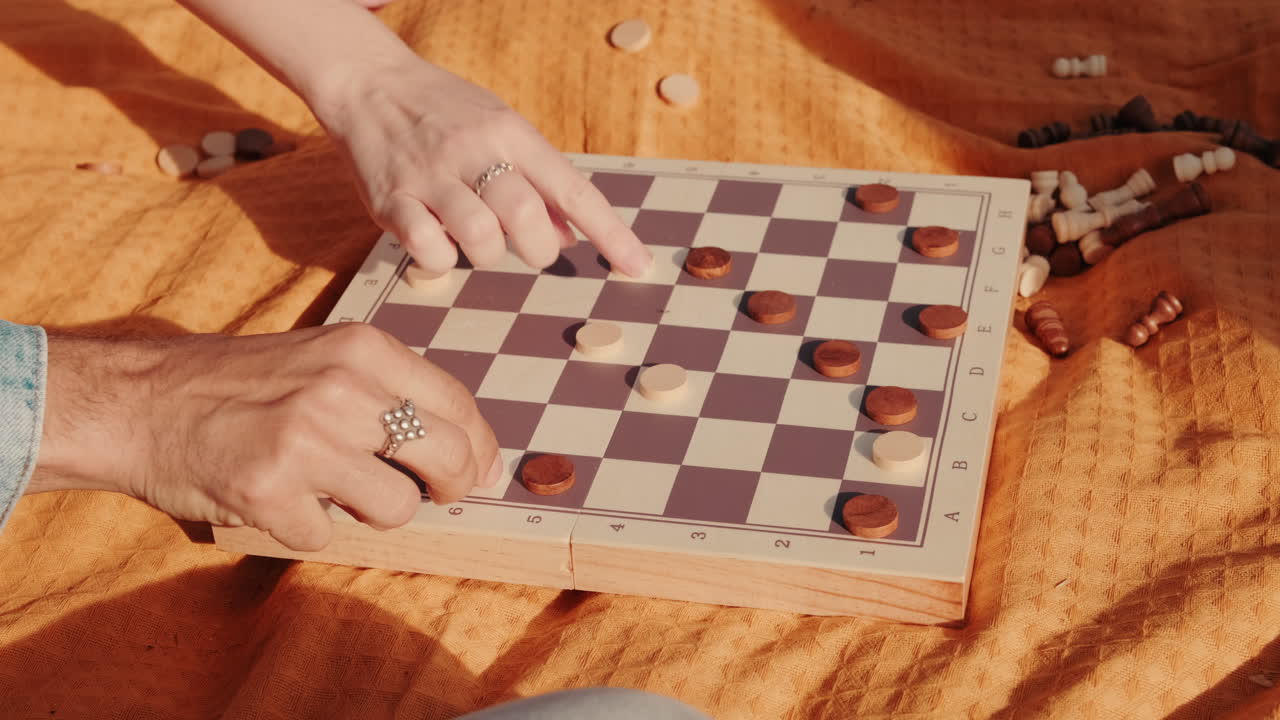 Friends Playing Checkers at a Picnic