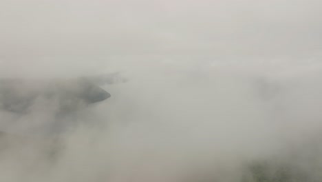 aerial drone fly above white clouds revealing lake mashu's volcanic waters landscape in hokkaido japan