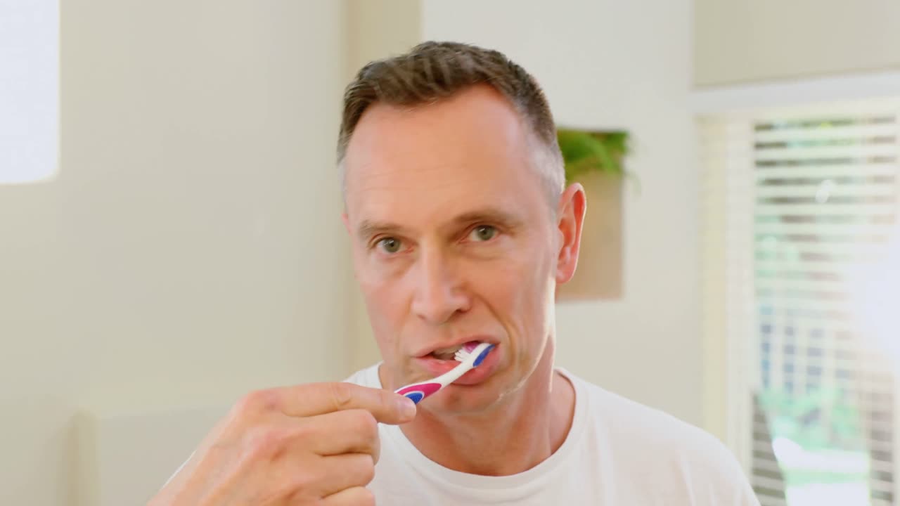 Man brushing his teeth with toothbrush 4k