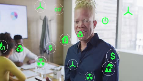 Animation-of-icons-over-albino-african-american-businessman-using-tablet-at-office