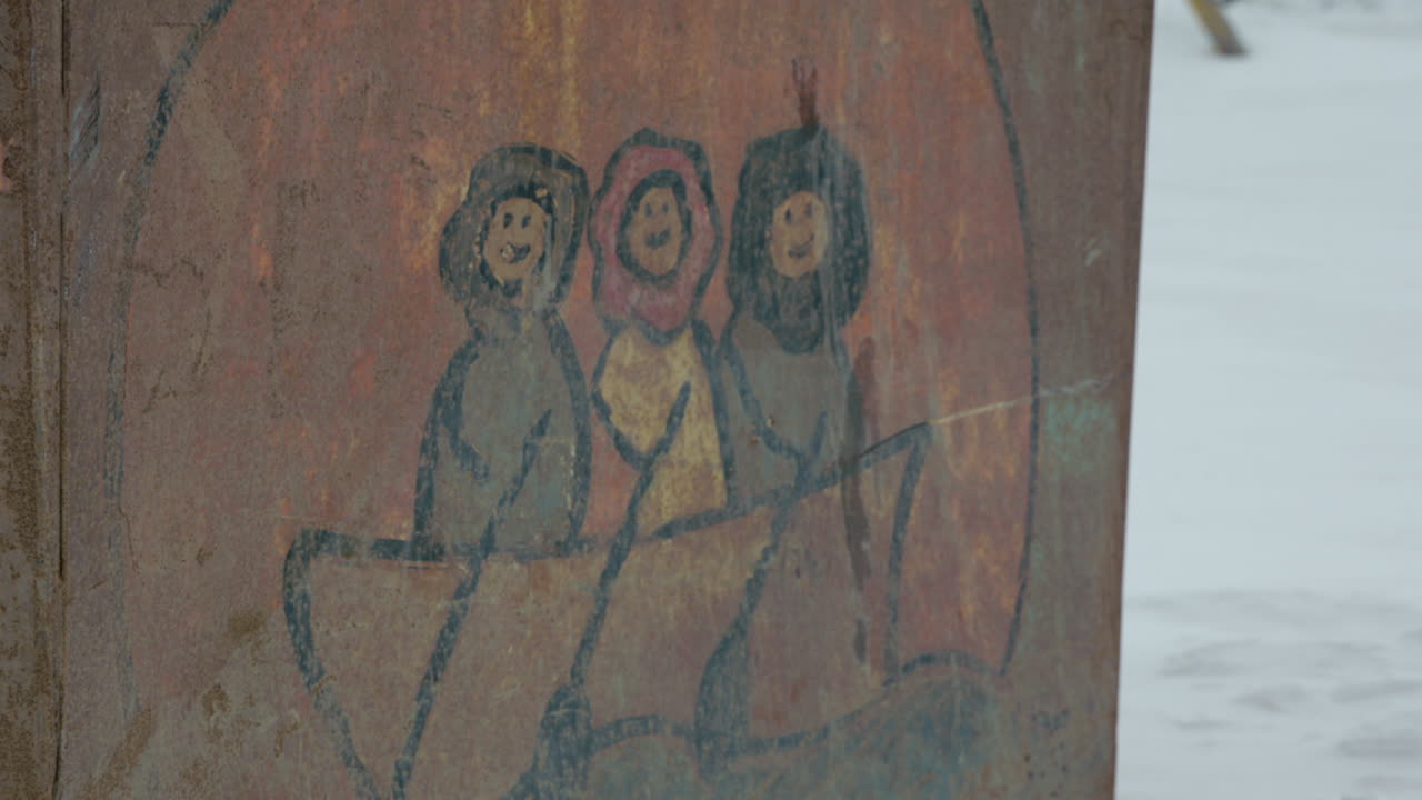 Closeup on I&ntilde;upiat artwork on Dumpster at Utqiagvik Barrow Alaska