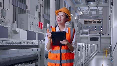 female engineer inspecting production line