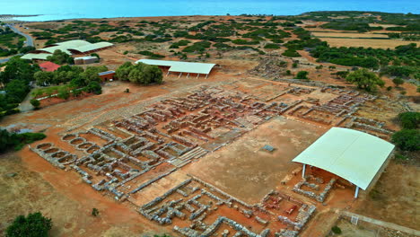panoramic drone shot circling the ruins of the palace of knossos in crete, greece