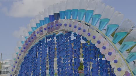 vibrant arch sculpture made of recycled materials