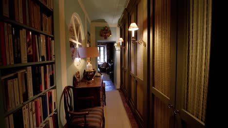 backward dolly in a house with a small library close with bookshelves