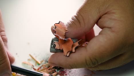 Footage-of-hands-slowly-sharpening-a-pencil-and-some-coloured-pencils-with-a-Wedge-Pencil-Sharpener