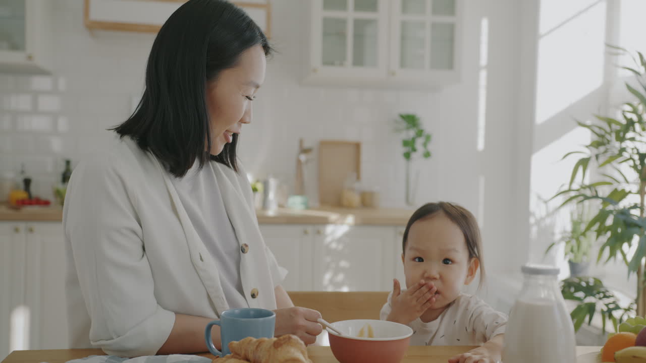 Mother and Daughter Enjoying Breakfast