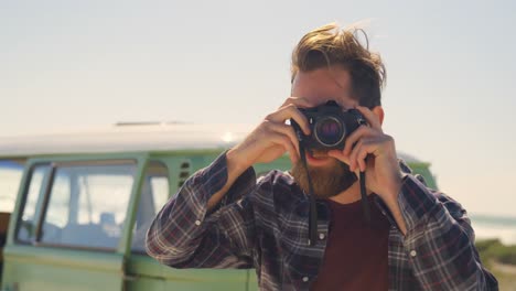 portrait of man clicking photo with digital camera 4k