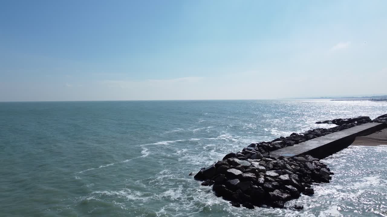 Serene Seascape: A Calm Ocean View with a Jetty