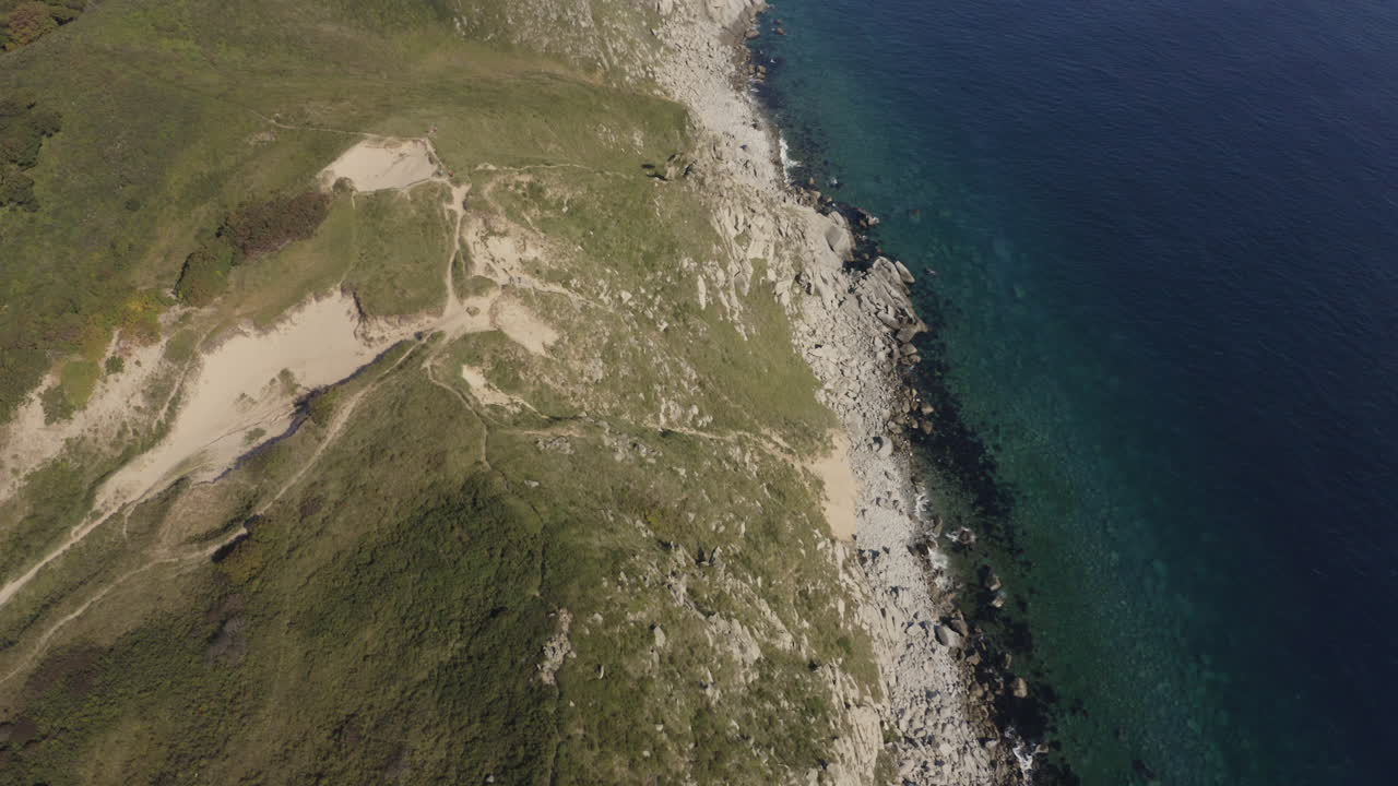 vista de pájaro de una impresionante costa rocosa escarpada y un océano azul profundo