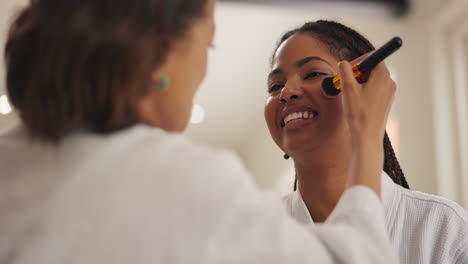 woman getting makeup applied