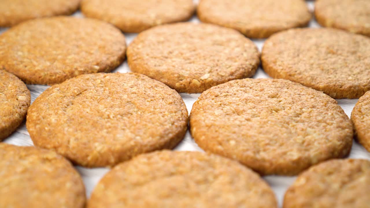 Freshly baked warm oatmeal cookies on a wooden background
