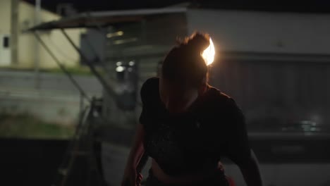 the artist performing a fire show at night is a sight to behold