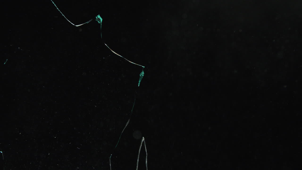 Glass shattering in Slow motion on black backdrop