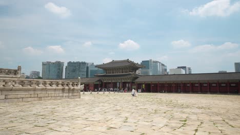 Gyeongbokgung-Palace---Geunjeongmun-Gate-with-Tourists-Sightseeing-on-summer-day-in-Seoul-against-blue-sky