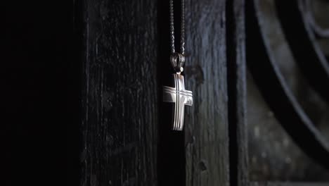 baptismal cross in church font of wooden door