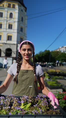 young woman selling flowers in urban market