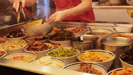 vendor preparing diverse dishes at food stall