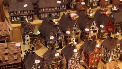 shopping for small scale alsace village homes at festive christmas market in strasbourg, france europe