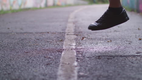 close up shot of young athletic man's shoes whilst he's jumping rope - skipping in an underpass, in slow motion