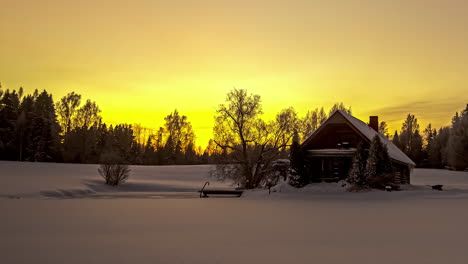 scenic winter wonderland sunset at snowy countryside with small wood house