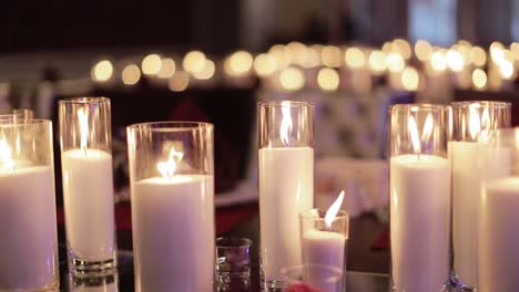 table set for an event party or wedding reception. decorative candles burning on a banquet table