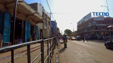 african market street scene: colorful clothing and textiles for sale