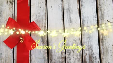 animation of seasons greetings text over christmas tree decorations