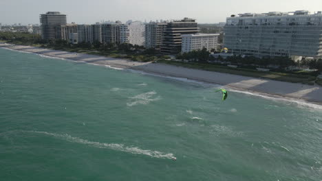 onshore aerial: miami beach kite surfers enjoy sunny, breezy play day