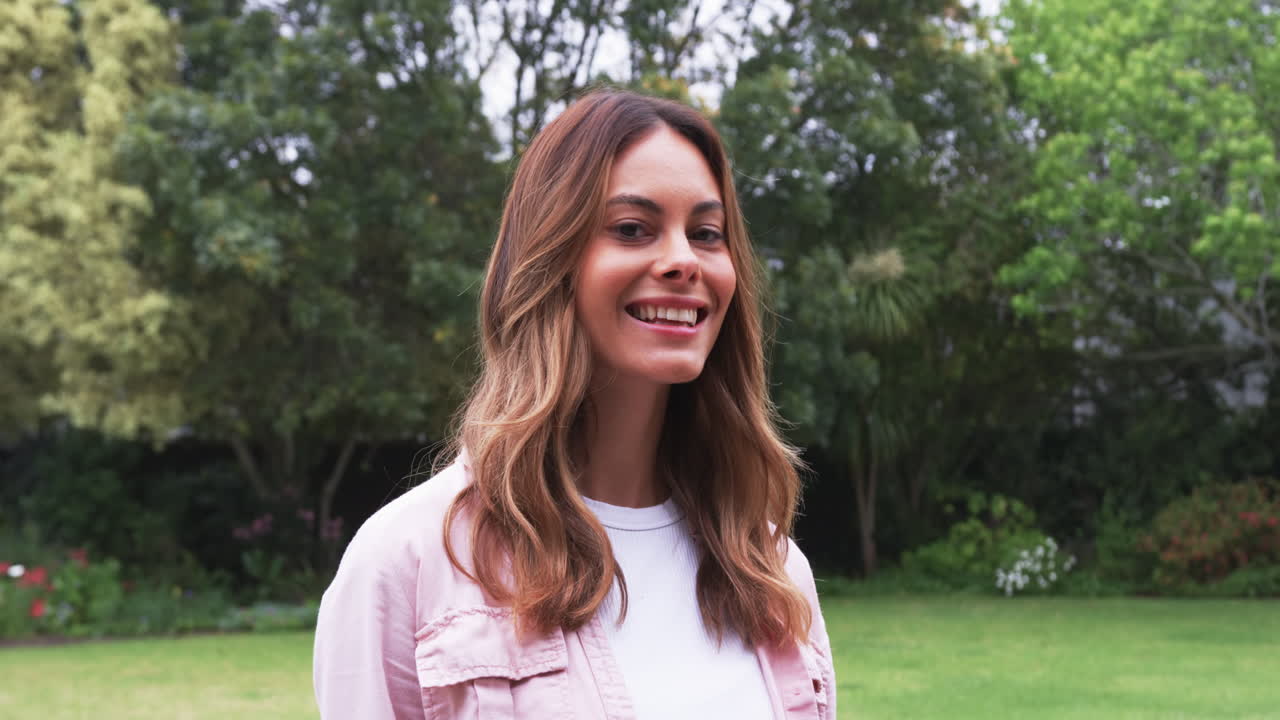 Portrait of smiling woman enjoying outdoor garden