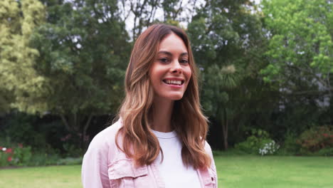 portrait of smiling woman enjoying outdoor garden