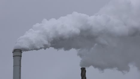 grey smoke coming out of a chimney