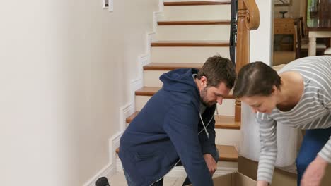 Couple-unpacking-cardboard-boxes-in-there-new-home-4K-4k