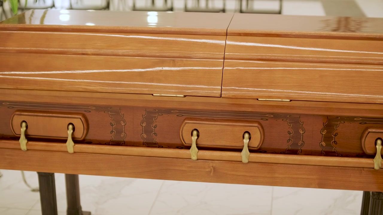 Polished Wooden Casket in Funeral Home Setting