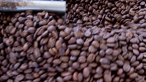 Extreme-closeup-of-freshly-roasted-dark-brown-coffee-beans-in-a-local-coffee-shop-in-Timor-Leste,-Southeast-Asia